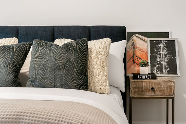 With a frame constructed from rubber wood and plywood, this bed features a headboard upholstered in a blue fabric with channeling. Solid rubber wood legs and an exposed wooden frame in a walnut finish complete the look. A box spring is not required for this bed.